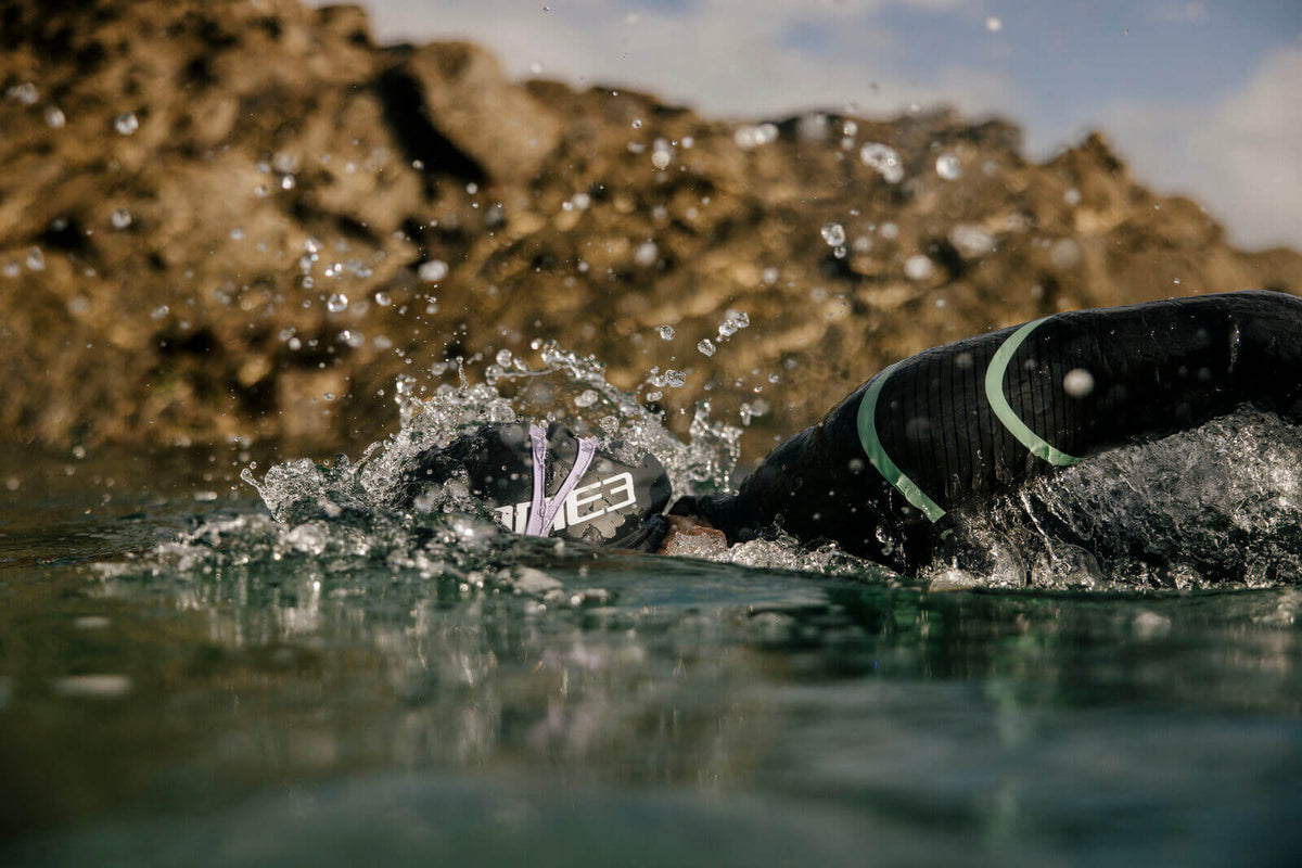 Athlete Swimming in open water wearing the Zone3 Glide wetsuit.