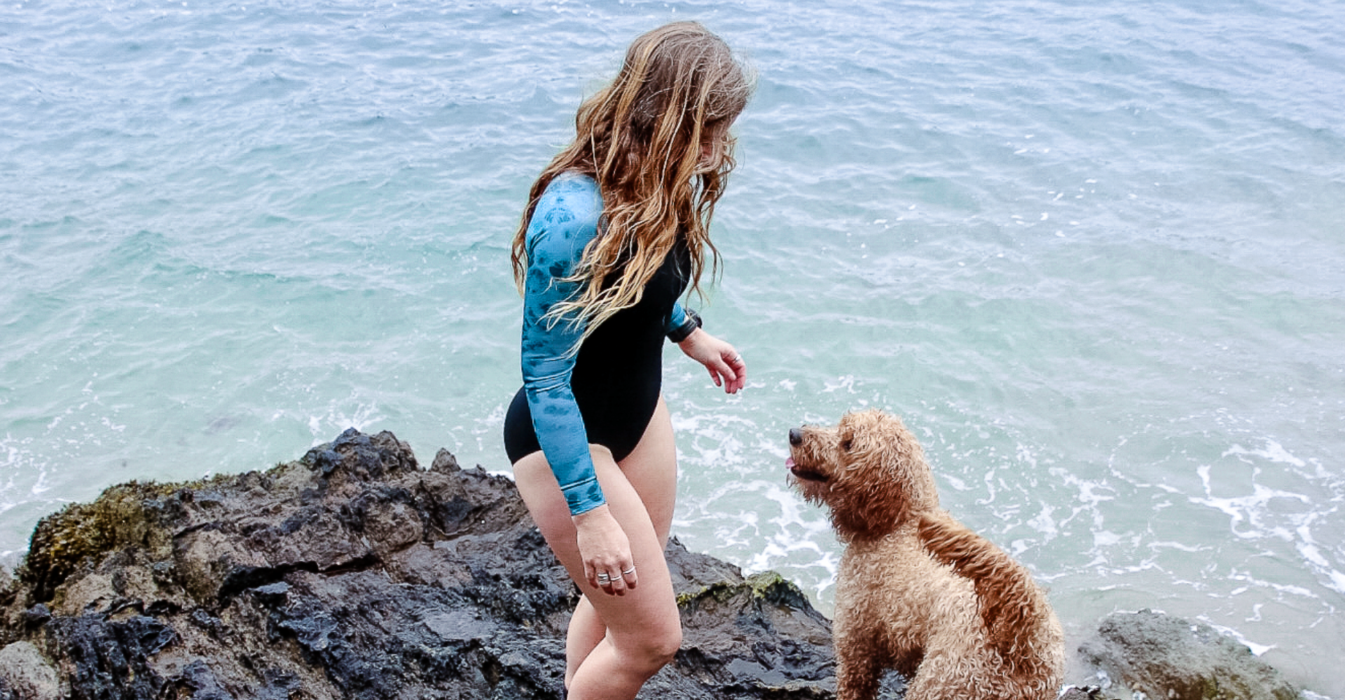 athlete wearing the Zone3 Women's Long Sleeve Swimsuit at the beach. 