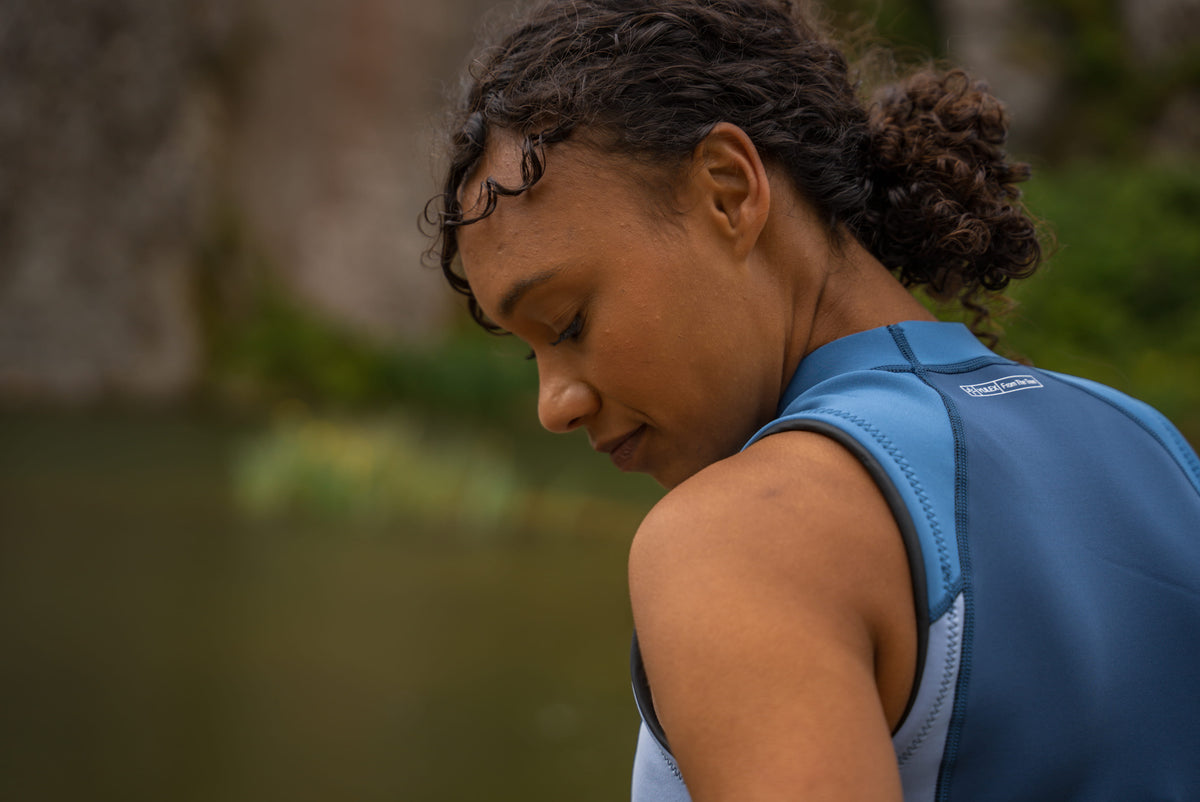 A close up of a Women wearing the Zone3 Yulex Vest in open water. 