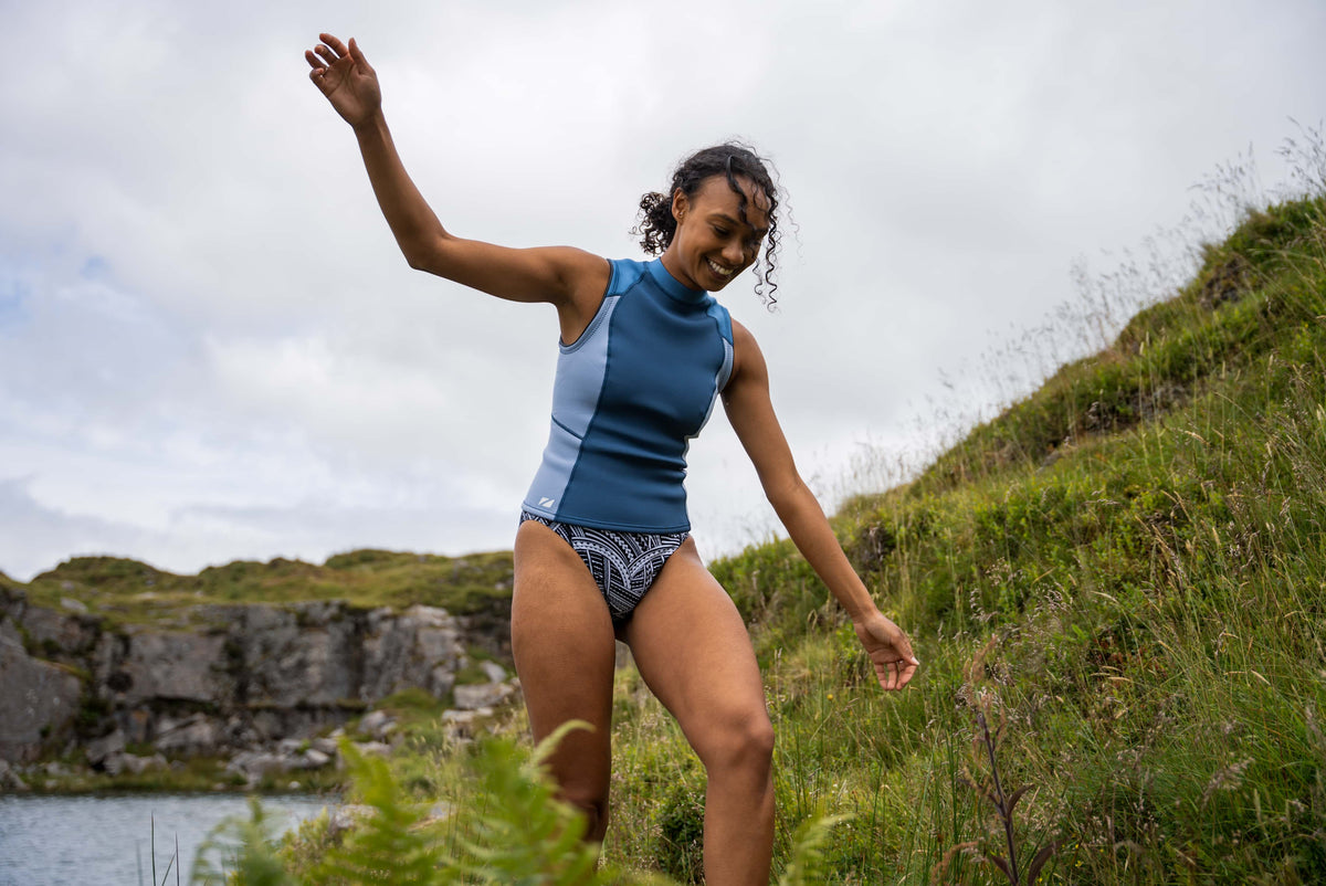 A Women wearing the Zone3 Yulex Vest in open water. 
