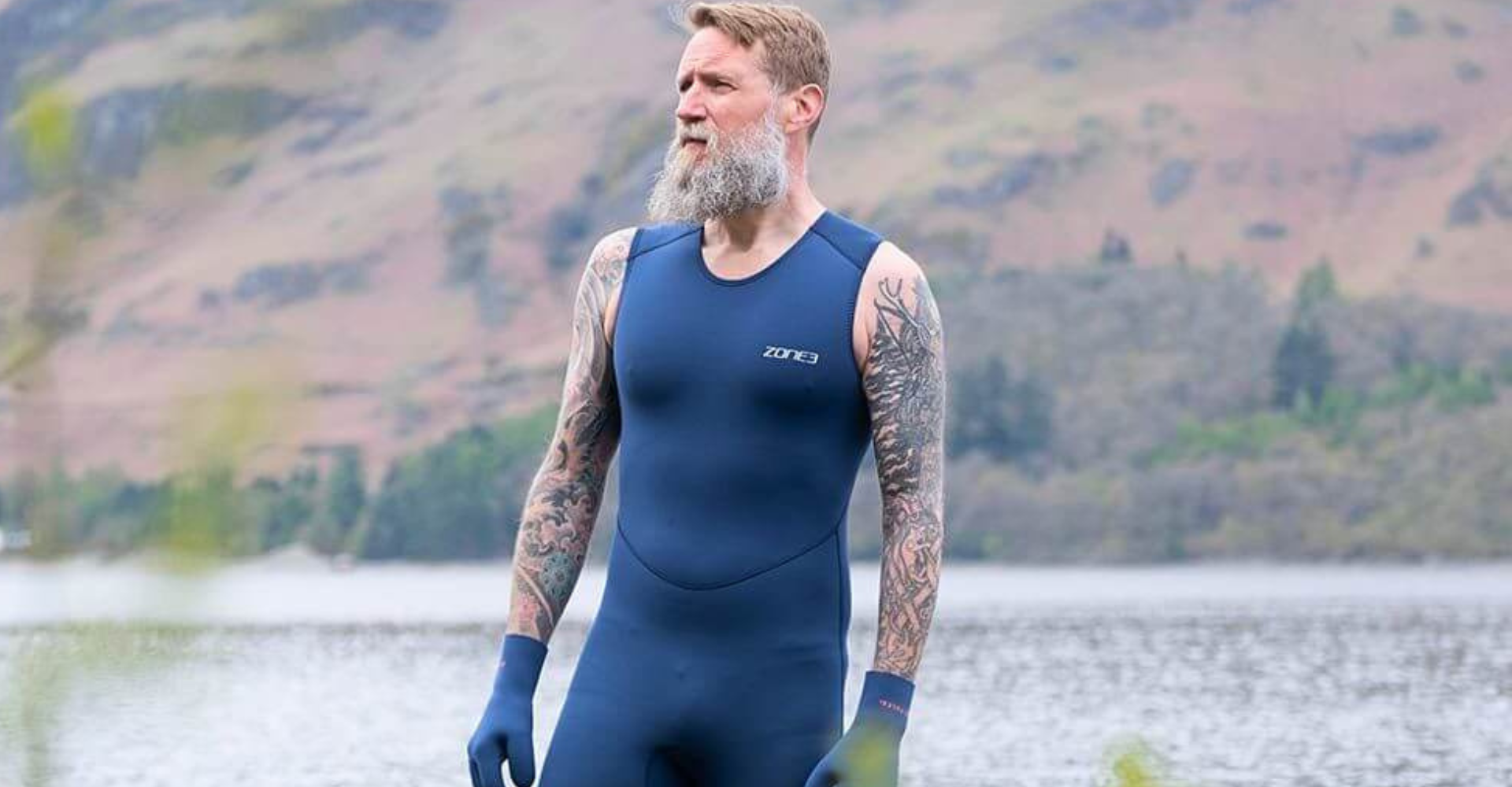 athlete wearing the Zone3 Yulex kneeskin in open water with gloves fro an outdoor swim. 
