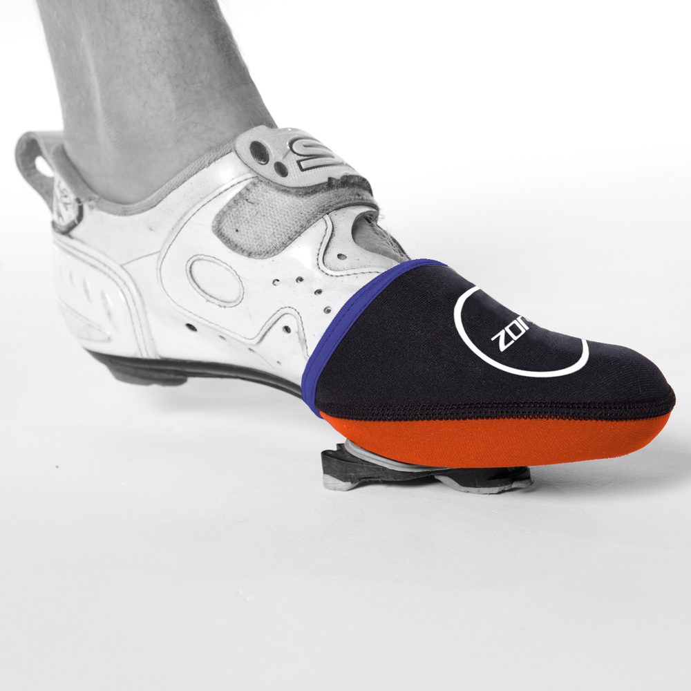 Close up of a cycling shoe with a blue and orange neoprene toe cap warmer.
