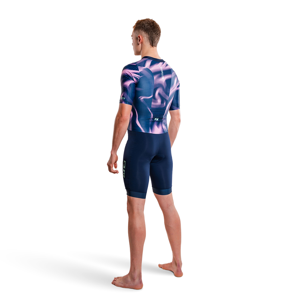Person wearing a purple and pink trisuit on a white background