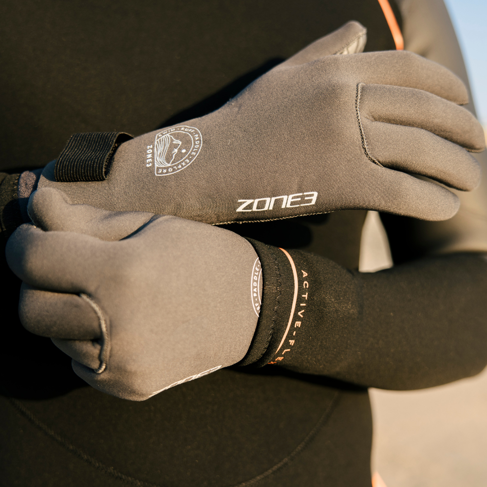Hands wearing Active-Flex Swim Gloves, providing protection for swimming, surfing, and paddle sports.