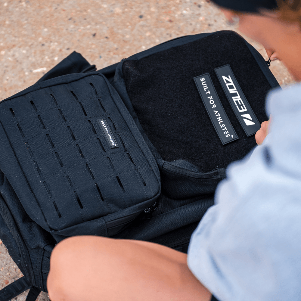 Built For Athletes x ZONE3 45L Transition Backpack open with pockets and bag patch.