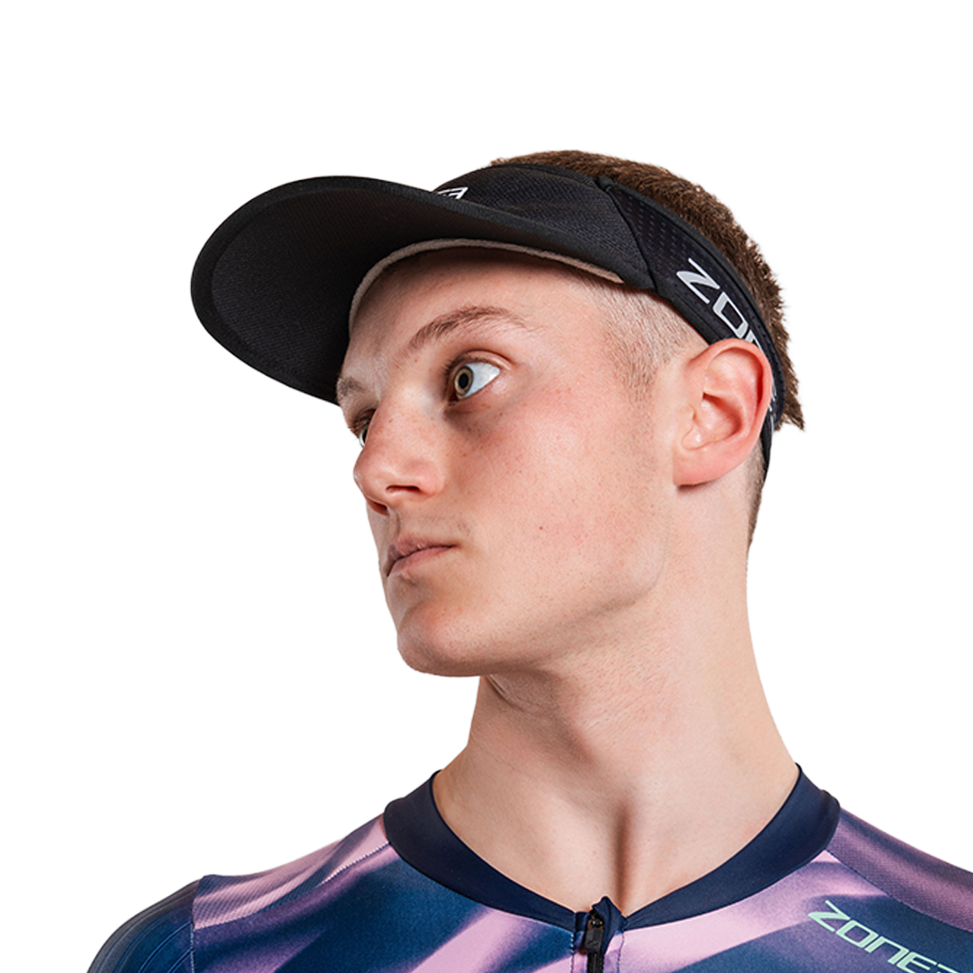 Man wearing zone3 black running visor with a zone3 logo on a white background