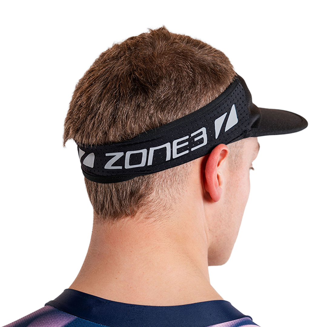 Man wearing zone3 black running visor with a zone3 logo on a white background