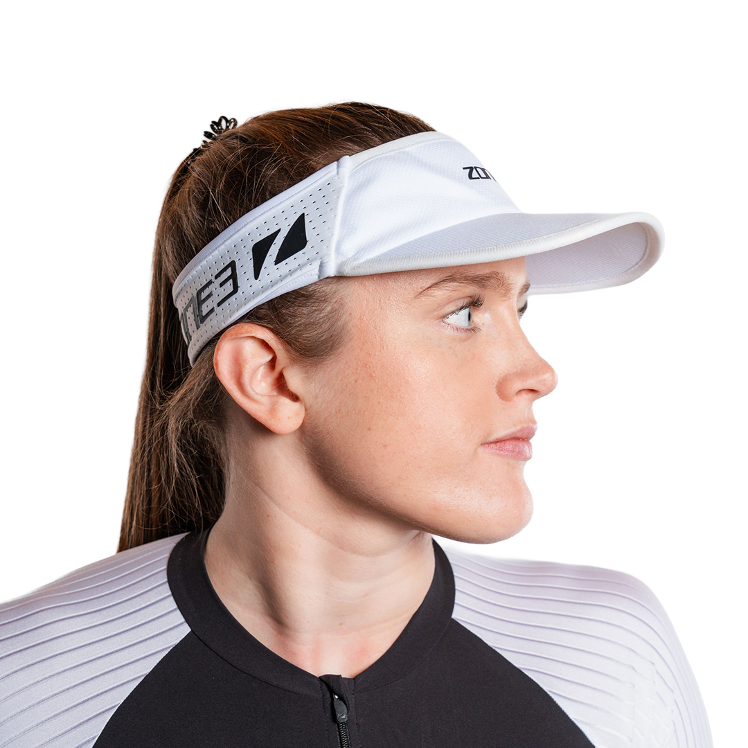 Woman wearing zone3 running white visor with a zone3 logo on a white background