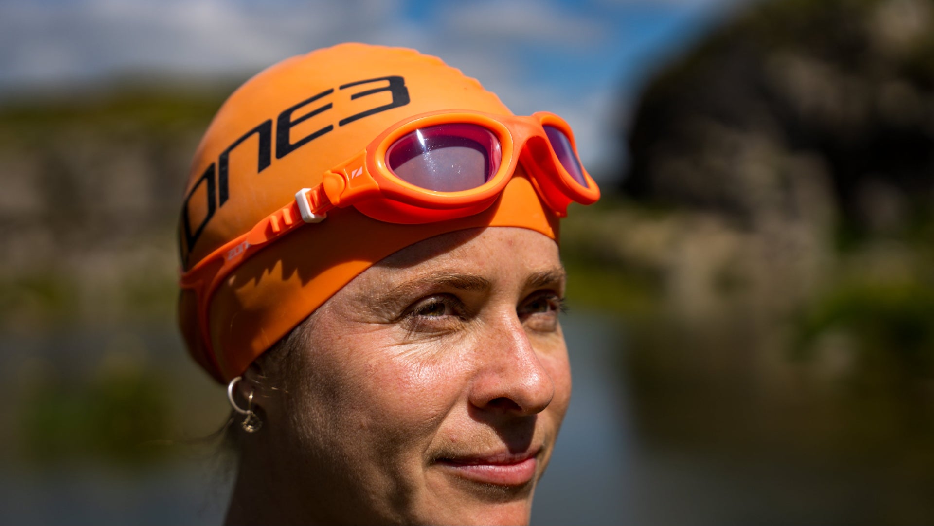 Close up of an athlete wearing Zone3 venator-x orange goggles