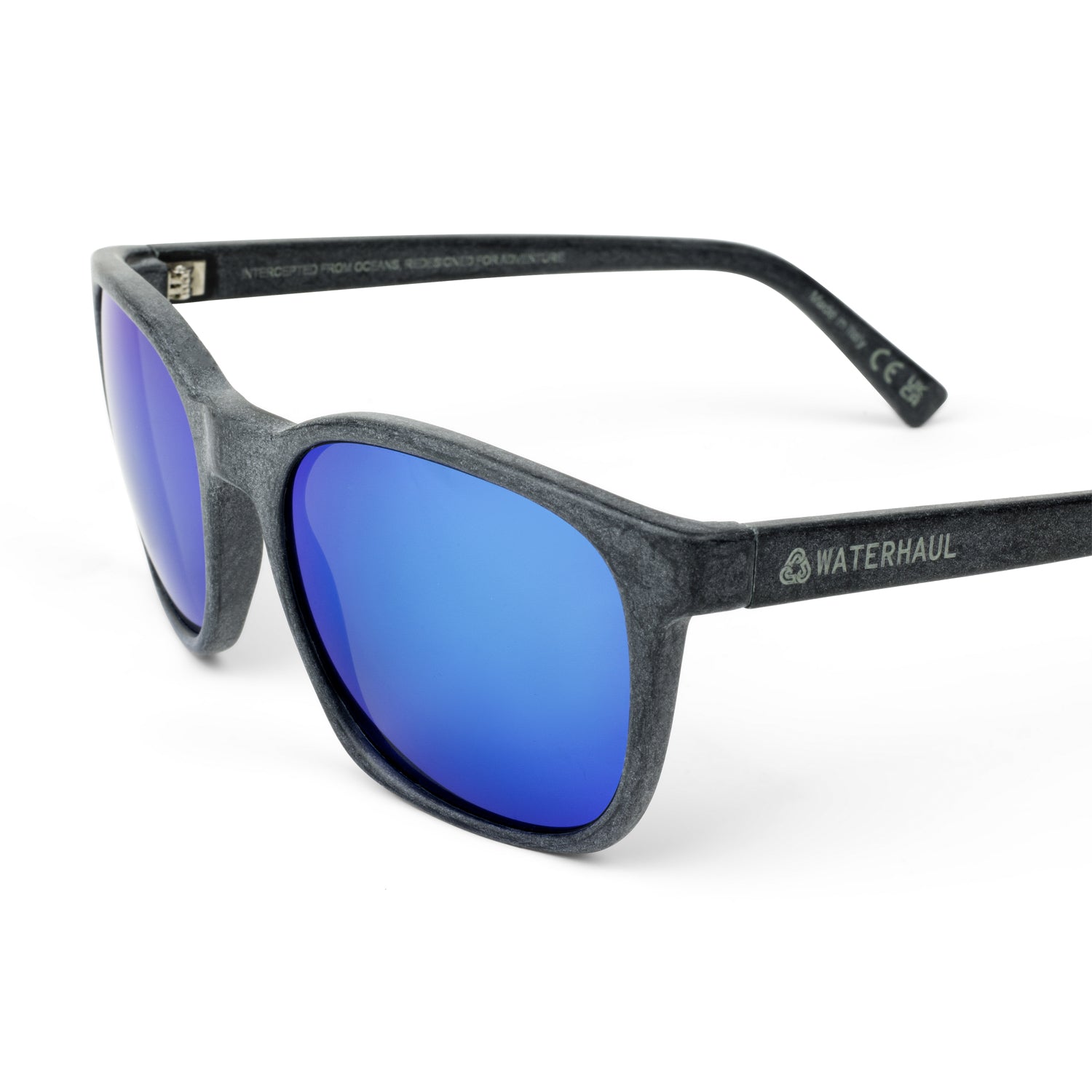 Waterhaul sunglasses with matte dark grey frames and vibrant blue mirrored polarized lenses, made from 100% recycled ocean plastic. Sleek, sustainable design built for outdoor performance and eco-conscious lifestyles.