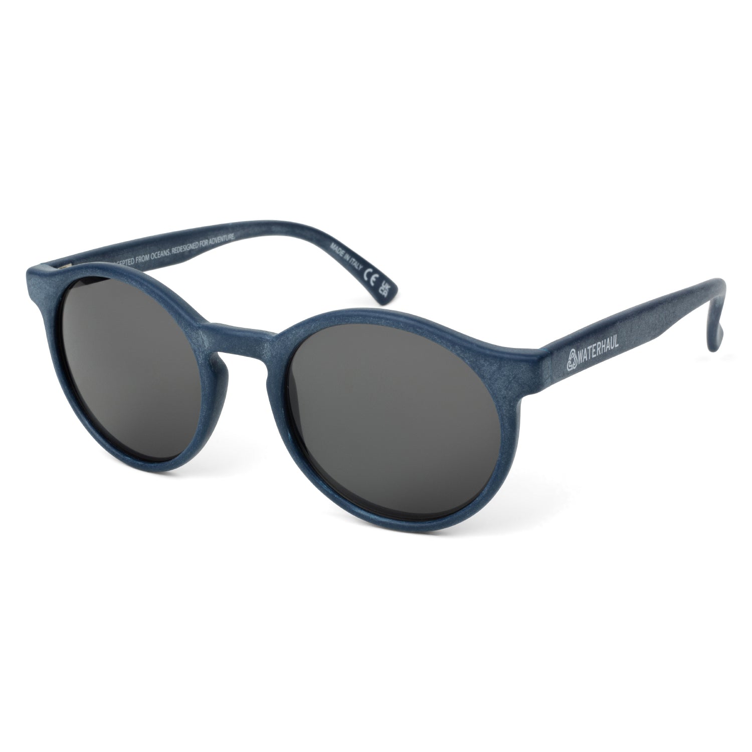 Waterhaul sunglasses with rounded matte blue frames and dark polarized lenses, made from 100% recycled ocean plastic. Eco-conscious, adventure-ready eyewear designed for sustainable living and outdoor performance.