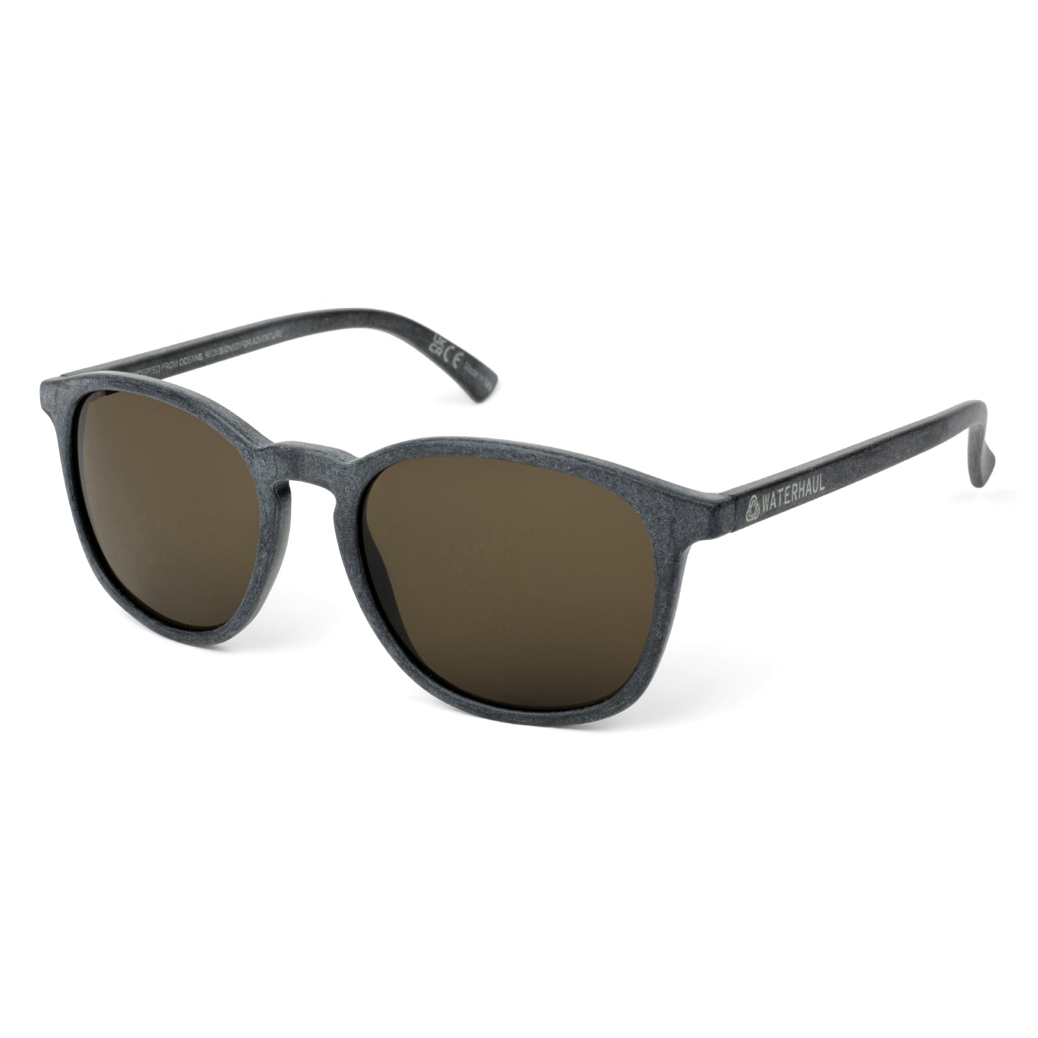 Waterhaul sunglasses with matte dark grey frames and brown polarized lenses, crafted from 100% recycled ocean plastic. Lightweight, sustainable eyewear with a subtle cat-eye silhouette, designed for active outdoor lifestyles.