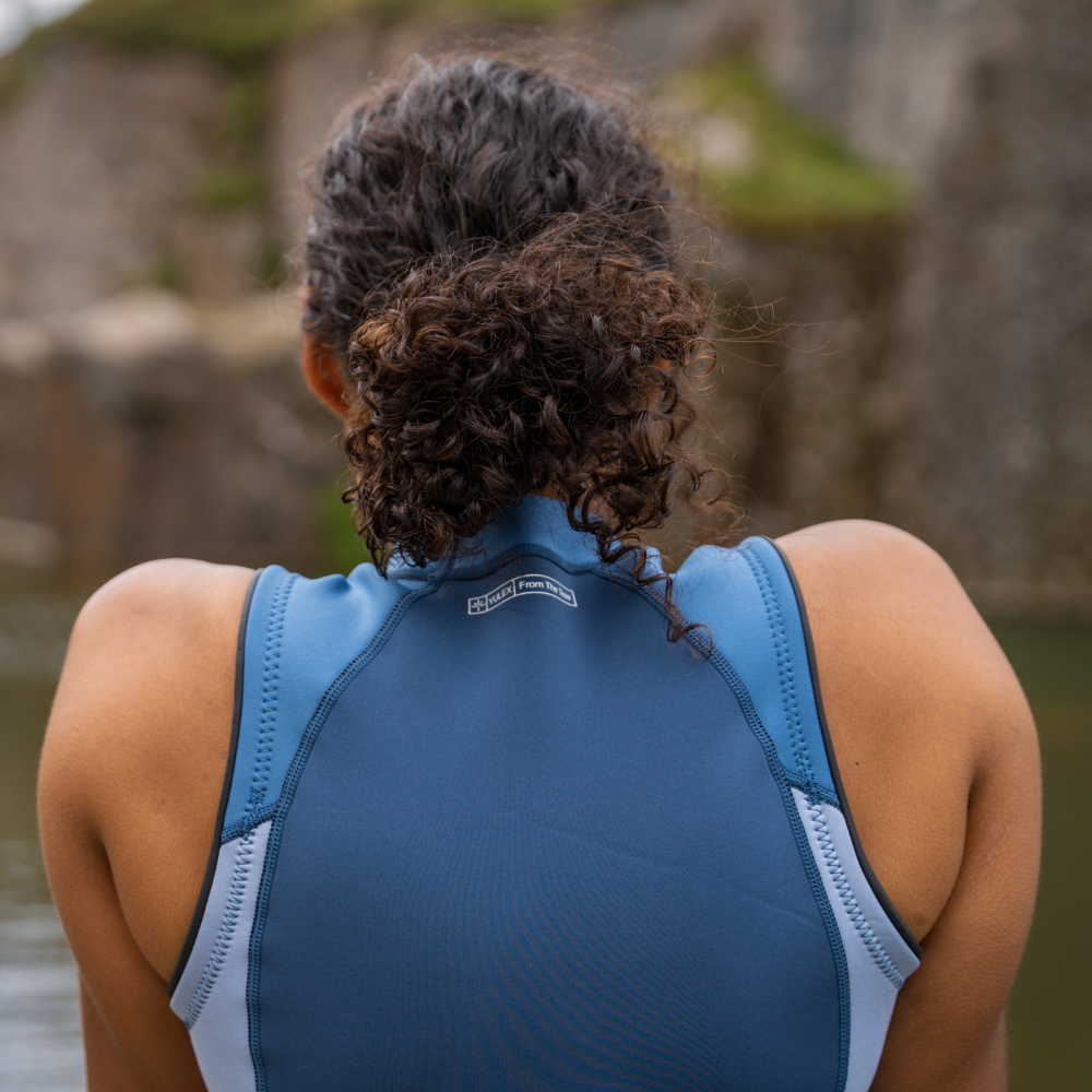 Yulex® Vest on a woman outdoors, showing versatility for swimming and surfing.