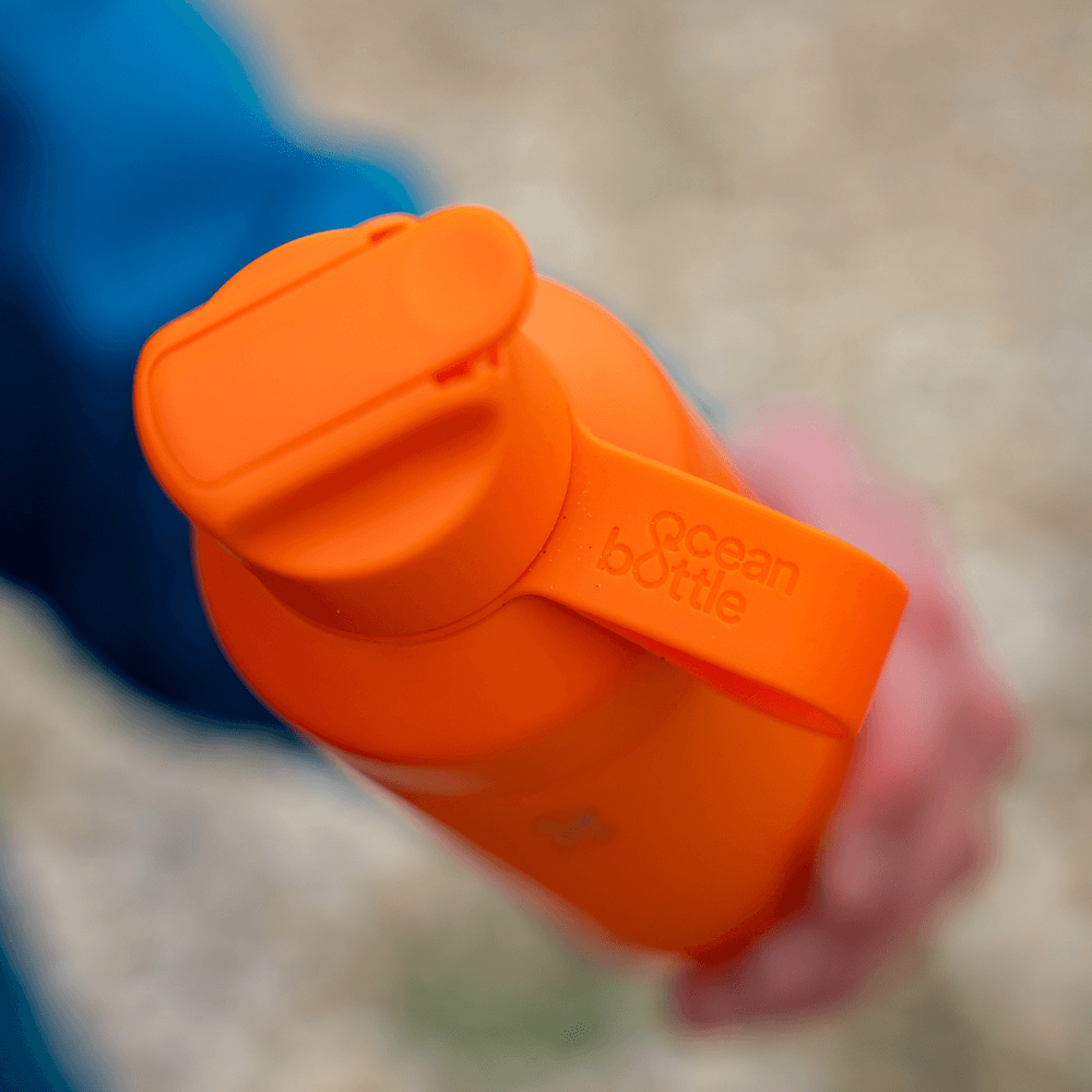 ZONE3 Ocean Bottle (500ml) in Sunshine Orange with a secure lid and handle for easy carrying.