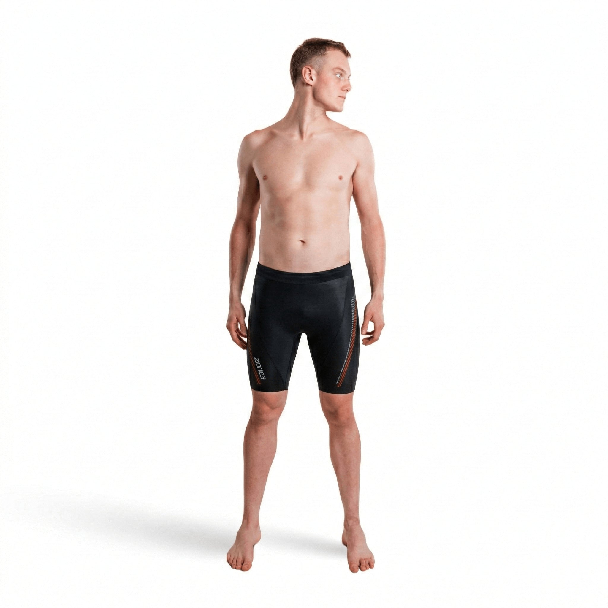 Front view of a shirtless man wearing premium 5/3mm buoyancy shorts in black with red panel accents.